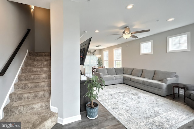 living area featuring recessed lighting, wood finished floors, ceiling fan, and stairs