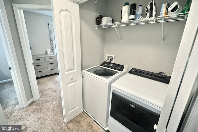 laundry area with washer and clothes dryer, baseboards, laundry area, and light carpet