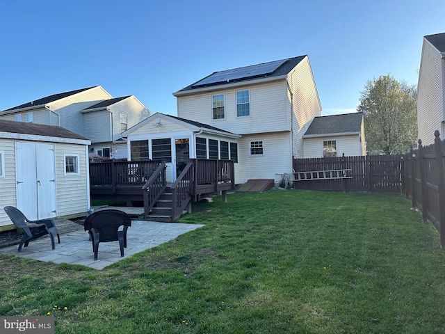 603 Shelter Cove St, Edgewood, MD 21040 - rear view of house featuring a patio, a deck, a storage unit, an outdoor structure, and a sunroom