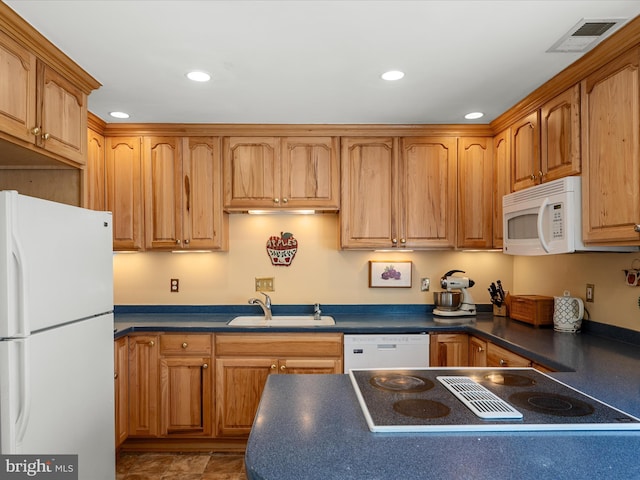 kitchen with a sink, dark countertops, visible vents, recessed lighting, and white appliances