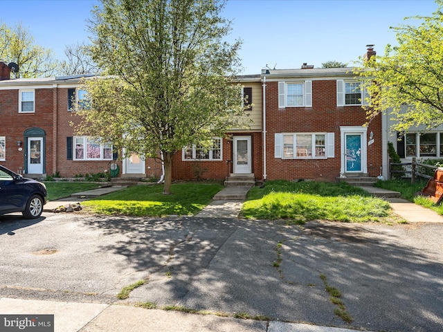 townhome / multi-family property with brick siding and entry steps