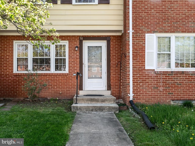 property entrance with brick siding