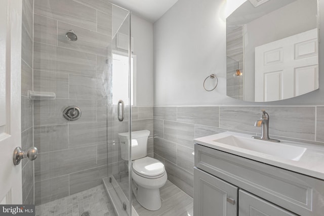 5634 6th St N, Arlington, VA 22205 - full bathroom featuring vanity, a stall shower, toilet, and tile walls