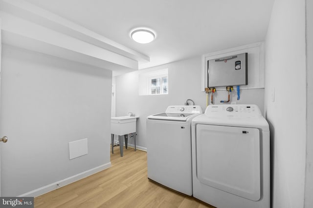 5634 6th St N, Arlington, VA 22205 - laundry area with independent washer and dryer, light wood-style floors, and baseboards
