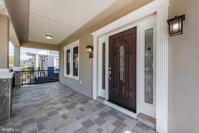 5634 6th St N, Arlington, VA 22205 - doorway to property featuring stucco siding and covered porch