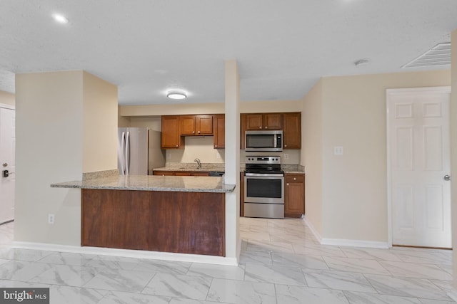 kitchen featuring appliances with stainless steel finishes, visible vents, marble finish floor, and a sink