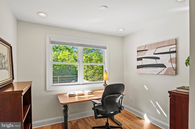 home office featuring baseboards and wood finished floors