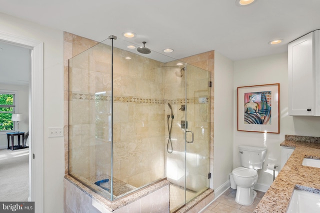 bathroom featuring vanity, toilet, baseboards, recessed lighting, and a stall shower