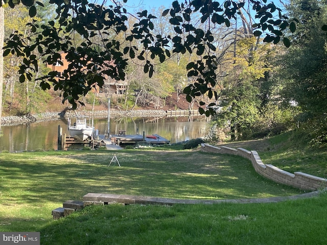 exterior space featuring a boat dock and a water view