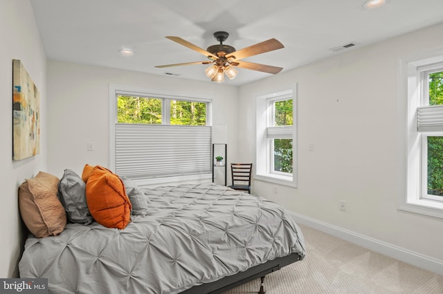 carpeted bedroom with visible vents, recessed lighting, baseboards, and multiple windows