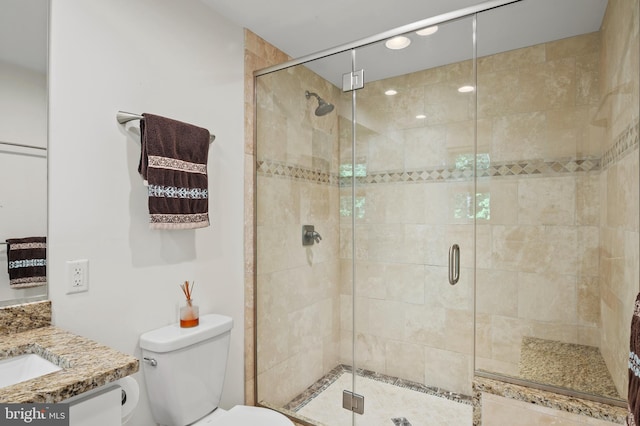 bathroom featuring vanity, toilet, recessed lighting, and a stall shower