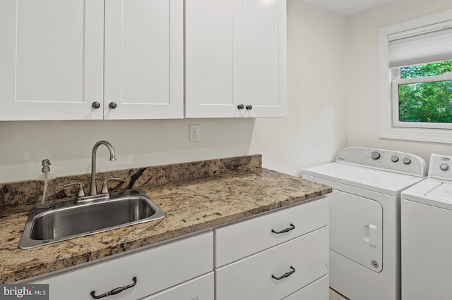 laundry room with a sink, cabinet space, and independent washer and dryer