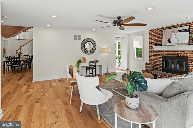 living area with visible vents, stairs, ceiling fan, and baseboards