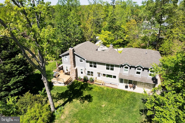 aerial view featuring a wooded view