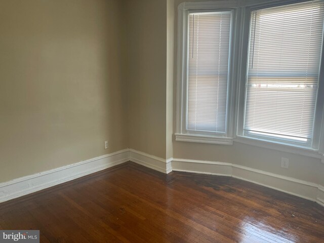 404 N 52nd St, Philadelphia, PA 19139 - unfurnished room featuring baseboards and dark wood-style flooring