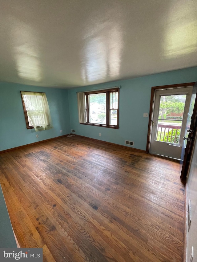 415 W Maple Rd, Linthicum Heights, MD 21090 - spare room featuring baseboards, a healthy amount of sunlight, and dark wood-style floors