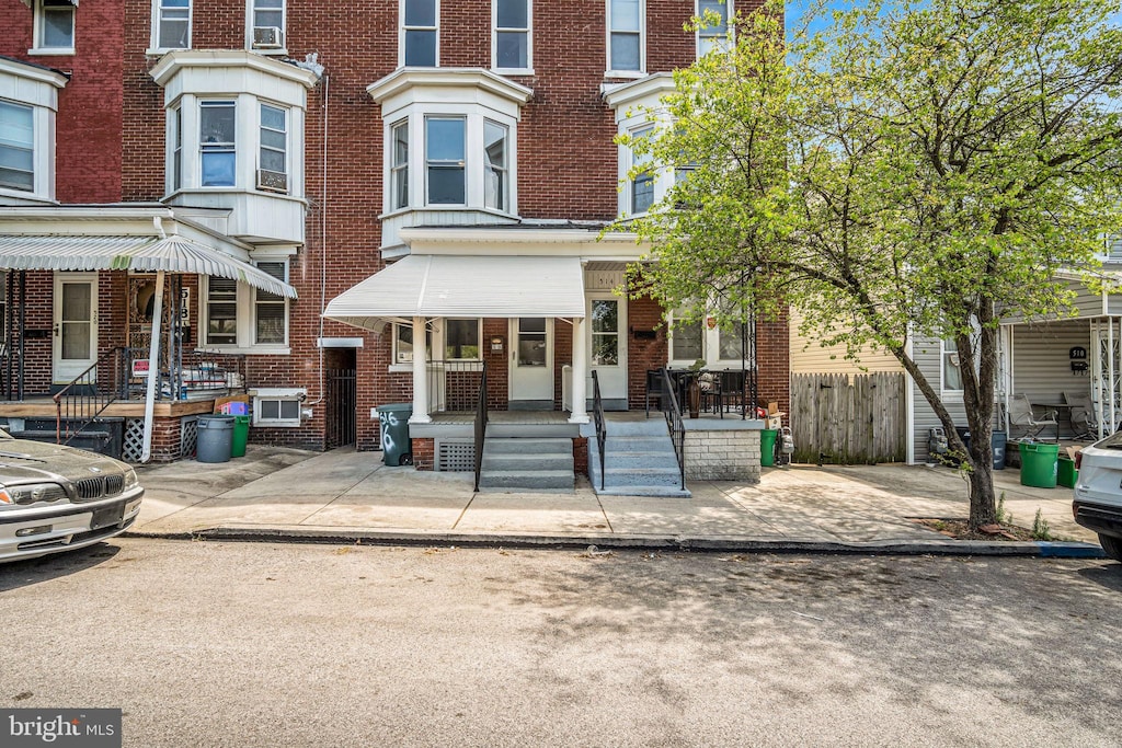 516 Wallace St, York, PA 17403 - view of property with brick siding, fence, and a porch