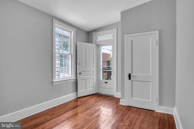 entrance foyer with baseboards and hardwood / wood-style floors