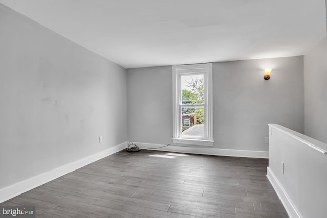 empty room featuring baseboards and wood finished floors