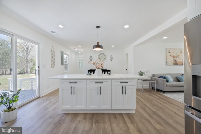 2475 W Denneys Rd, Dover, DE 19904 - kitchen with recessed lighting, stainless steel fridge, visible vents, and light wood finished floors