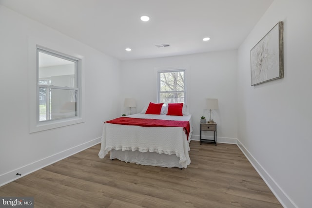 2475 W Denneys Rd, Dover, DE 19904 - bedroom featuring baseboards, wood finished floors, visible vents, and recessed lighting