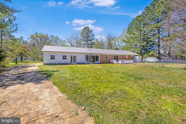 2475 W Denneys Rd, Dover, DE 19904 - view of front of home featuring fence, a front yard, and metal roof