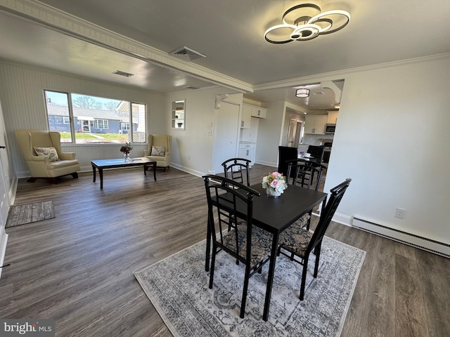 dining room with baseboards, visible vents, baseboard heating, and ornamental molding
