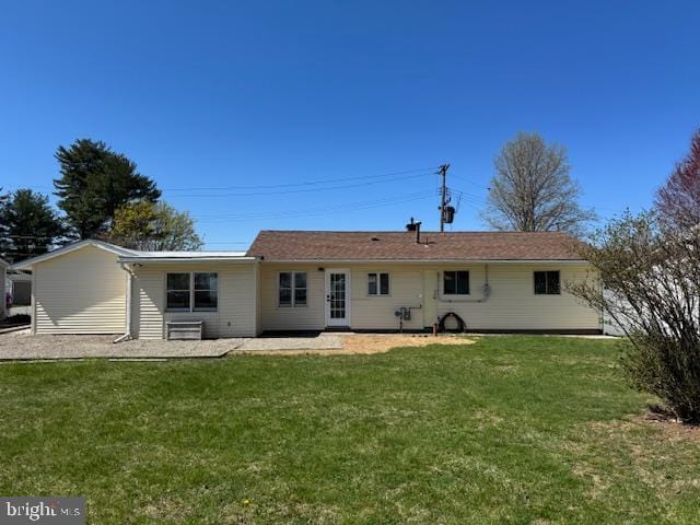 back of property with a yard