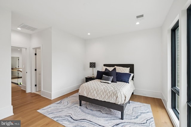 bedroom featuring recessed lighting, baseboards, visible vents, and light wood-type flooring