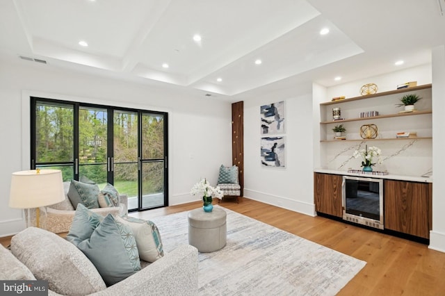 living area featuring visible vents, light wood-style floors, wine cooler, and recessed lighting