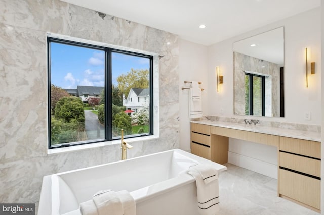 bathroom featuring vanity, marble finish floor, a soaking tub, and recessed lighting