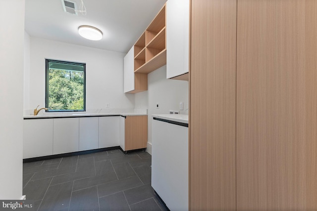 kitchen with white cabinetry, open shelves, visible vents, and light countertops