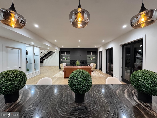dining area featuring recessed lighting, baseboards, light wood-style floors, and stairs