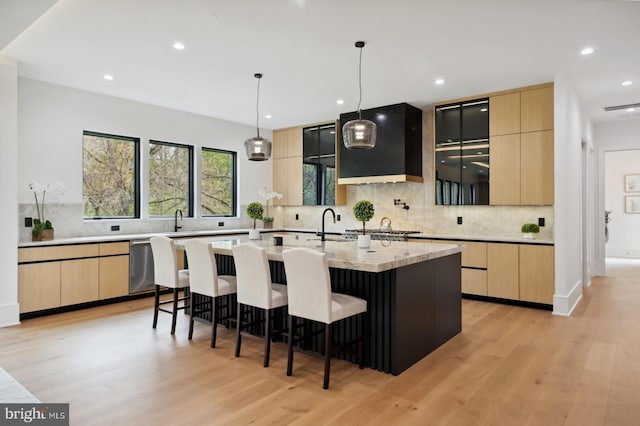kitchen with light brown cabinetry and modern cabinets