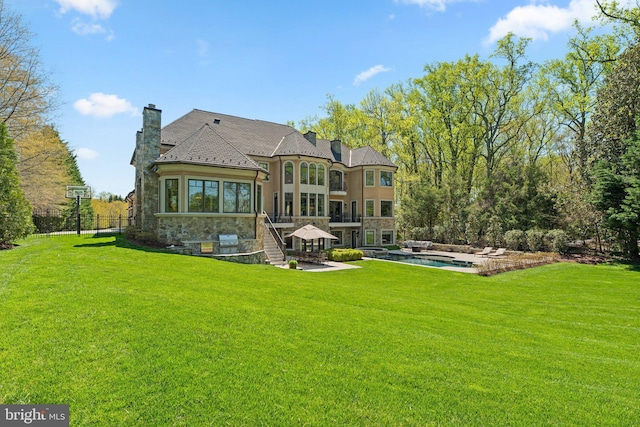 840 Childs Point Rd, Annapolis, MD 21401 - back of property with a yard, a chimney, an outdoor pool, and stone siding