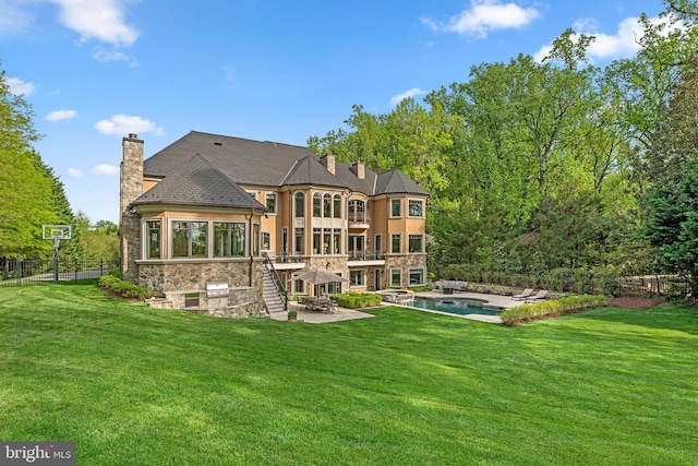 840 Childs Point Rd, Annapolis, MD 21401 - back of property with a chimney, a yard, a patio area, and stone siding