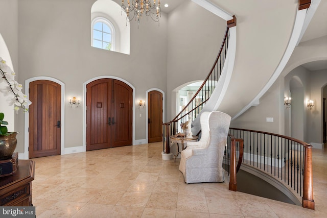 840 Childs Point Rd, Annapolis, MD 21401 - entryway with stairs, baseboards, a high ceiling, a chandelier, and arched walkways