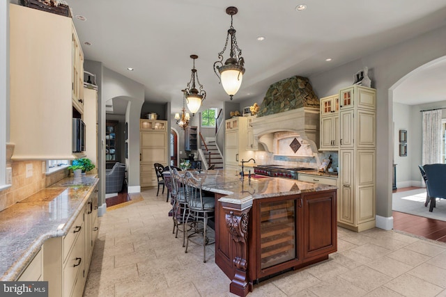 840 Childs Point Rd, Annapolis, MD 21401 - kitchen featuring wine cooler, arched walkways, cream cabinets, and recessed lighting