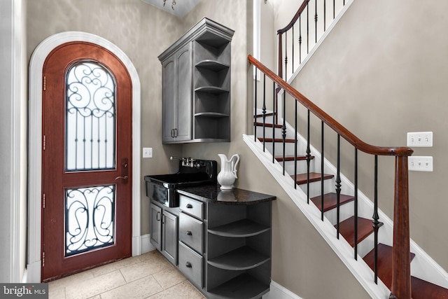 840 Childs Point Rd, Annapolis, MD 21401 - bar featuring baseboards, a sink, stairs, and arched walkways