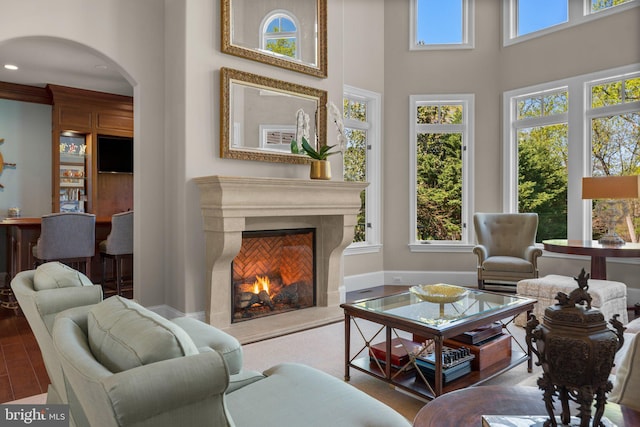 840 Childs Point Rd, Annapolis, MD 21401 - living area featuring arched walkways, a towering ceiling, and a premium fireplace