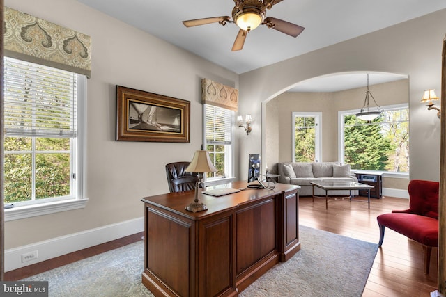 840 Childs Point Rd, Annapolis, MD 21401 - office featuring baseboards, arched walkways, wood finished floors, and a wealth of natural light