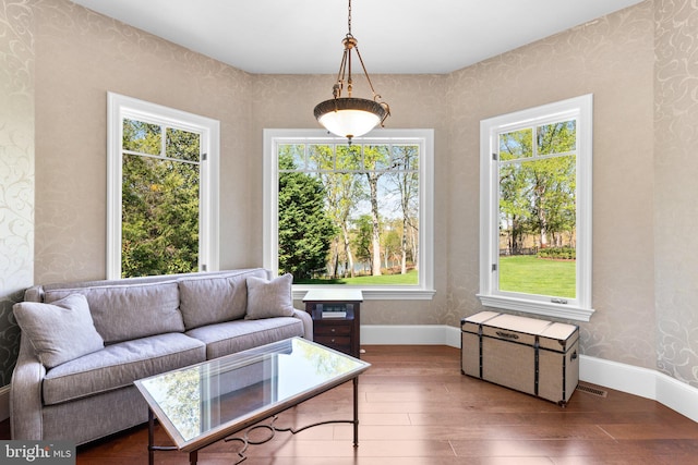 840 Childs Point Rd, Annapolis, MD 21401 - living area with baseboards, wallpapered walls, a healthy amount of sunlight, and hardwood / wood-style floors