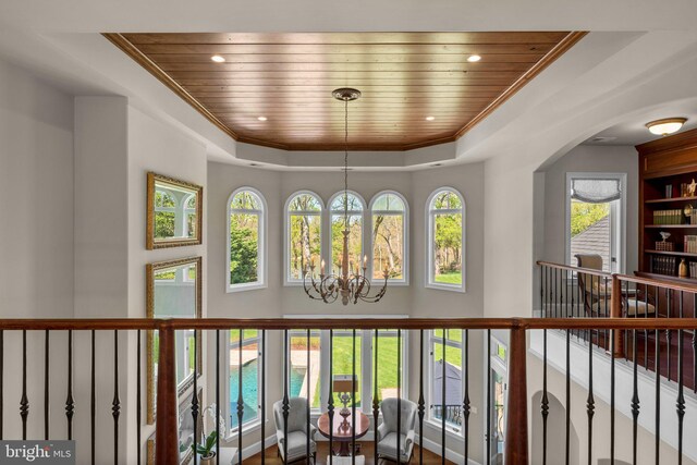 840 Childs Point Rd, Annapolis, MD 21401 - interior space with an inviting chandelier, a high ceiling, wood ceiling, a tray ceiling, and arched walkways