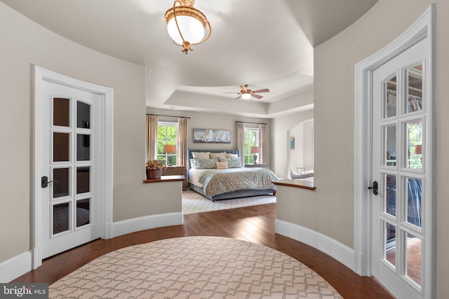 840 Childs Point Rd, Annapolis, MD 21401 - bedroom featuring dark wood-style flooring, baseboards, and a tray ceiling