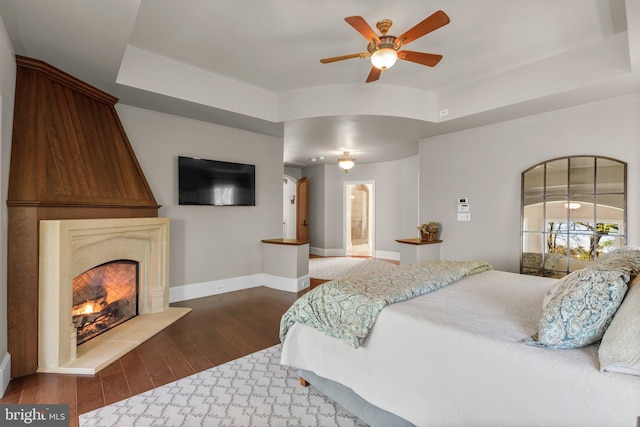 840 Childs Point Rd, Annapolis, MD 21401 - bedroom with a fireplace, baseboards, a ceiling fan, dark wood finished floors, and ensuite bath