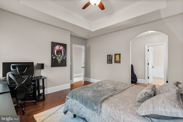 840 Childs Point Rd, Annapolis, MD 21401 - bedroom featuring arched walkways, baseboards, wood finished floors, and a tray ceiling