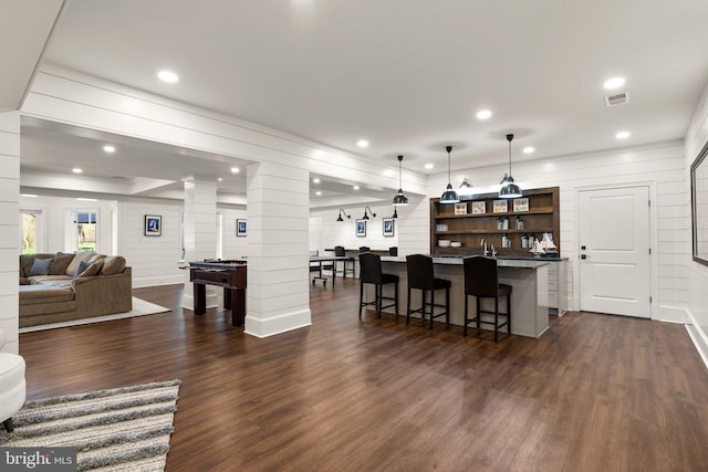 840 Childs Point Rd, Annapolis, MD 21401 - living room with decorative columns, visible vents, dark wood finished floors, bar area, and recessed lighting