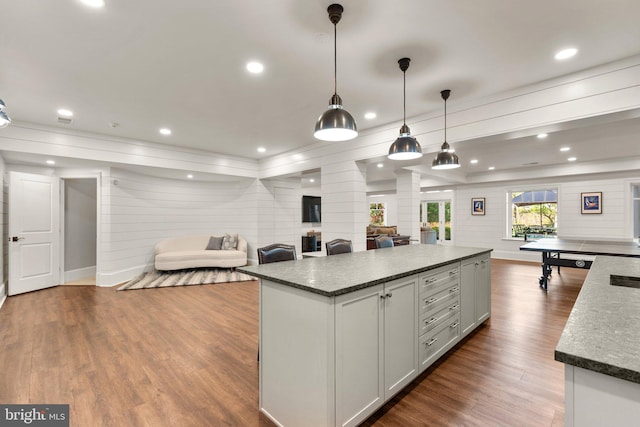 840 Childs Point Rd, Annapolis, MD 21401 - kitchen featuring wooden walls, a center island, decorative columns, wood finished floors, and ornamental molding