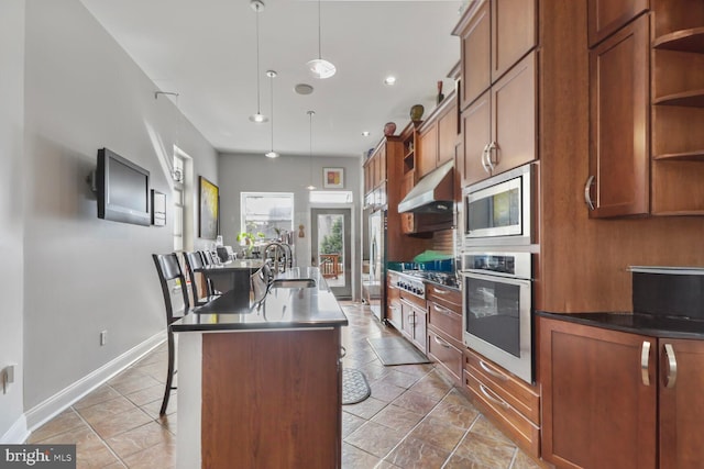 2103 Bolton St, Baltimore, MD 21217 - kitchen with appliances with stainless steel finishes, open shelves, a center island with sink, a sink, and under cabinet range hood
