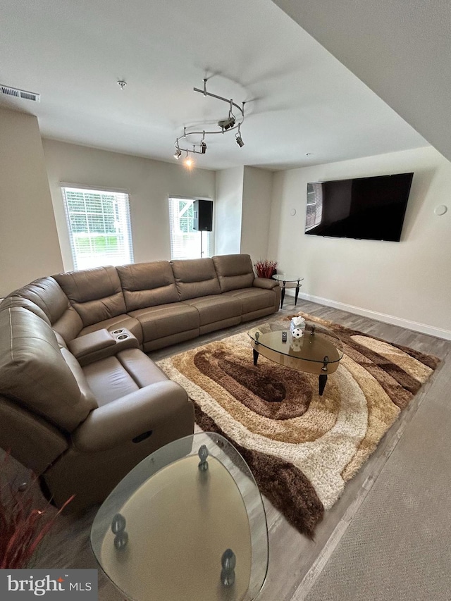 living room featuring visible vents and wood finished floors